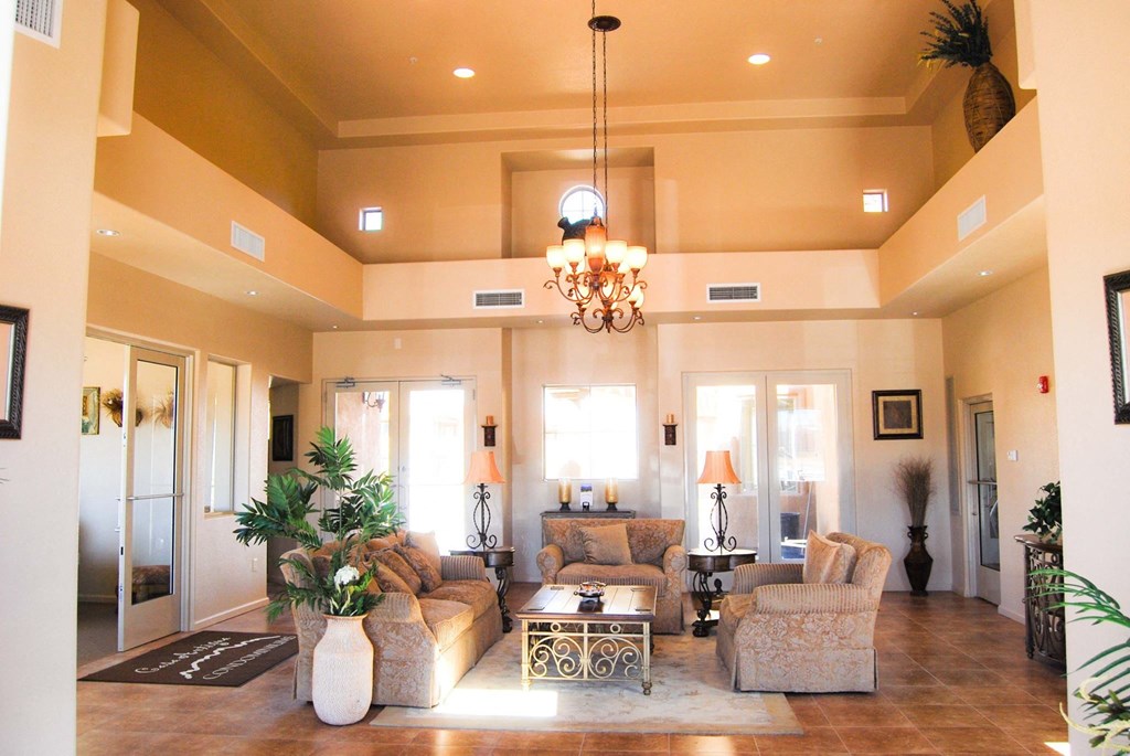 a large living room with furniture and a chandelier