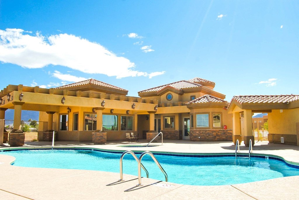 a large swimming pool in front of a house