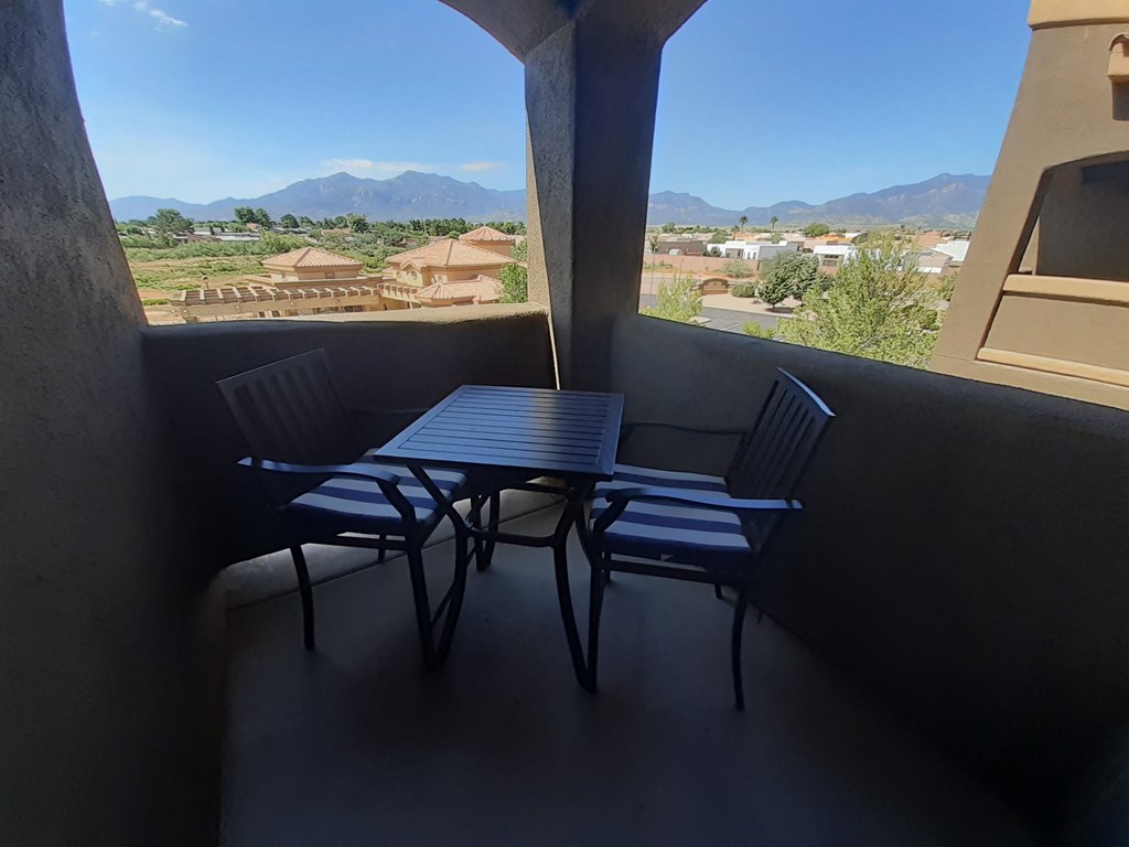 a patio with a table and chairs on a balcony