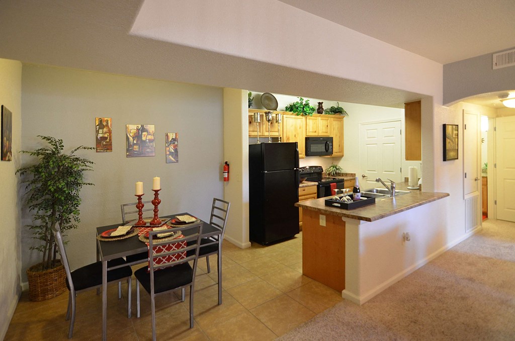 an open kitchen and dining room with a table and chairs