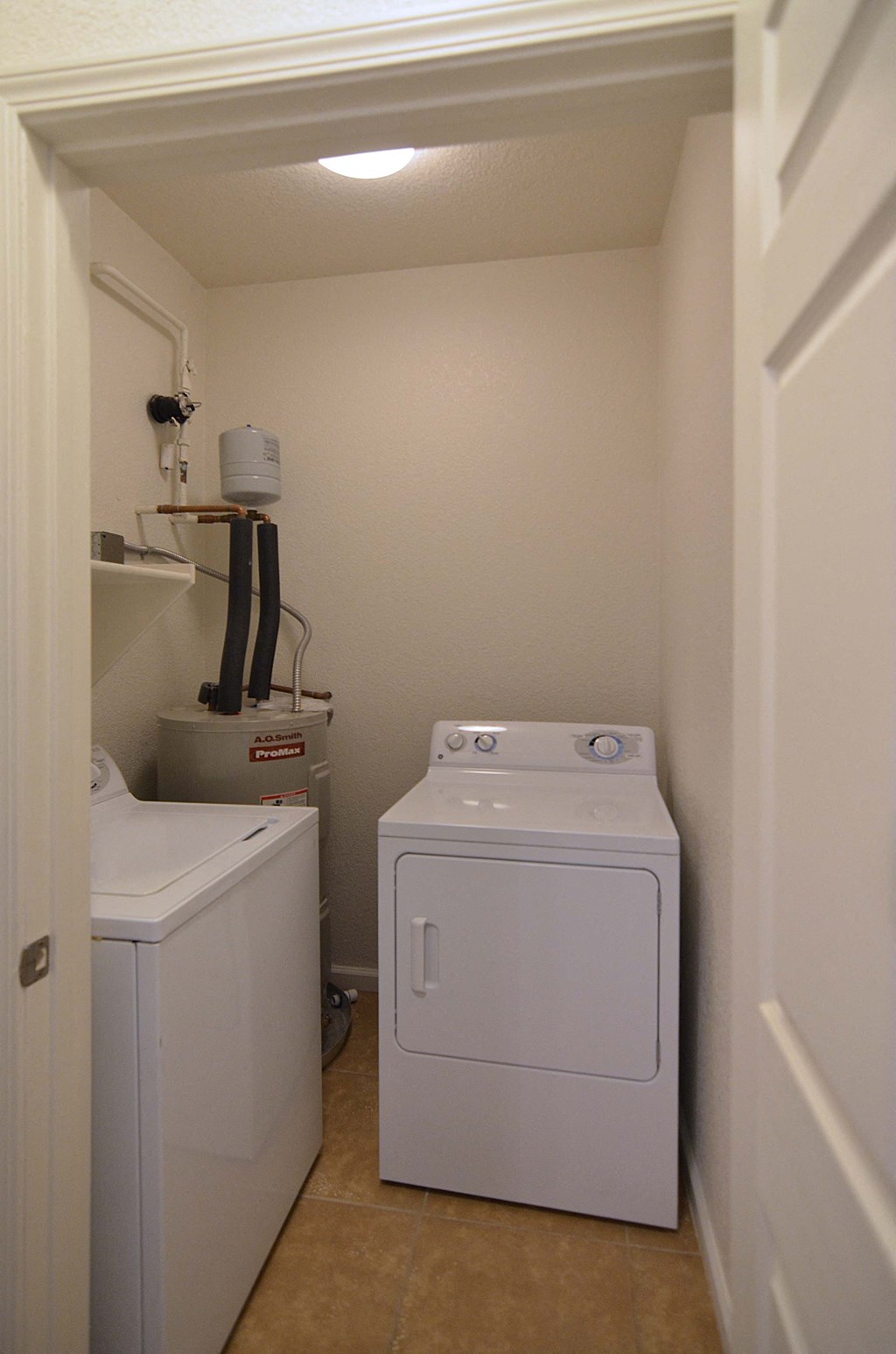 a small laundry room with a washer and dryer
