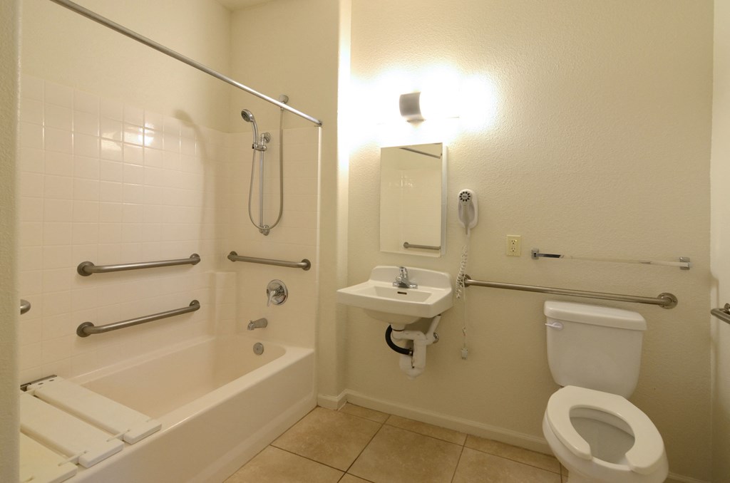 a bathroom with a toilet and a sink and a bath tub