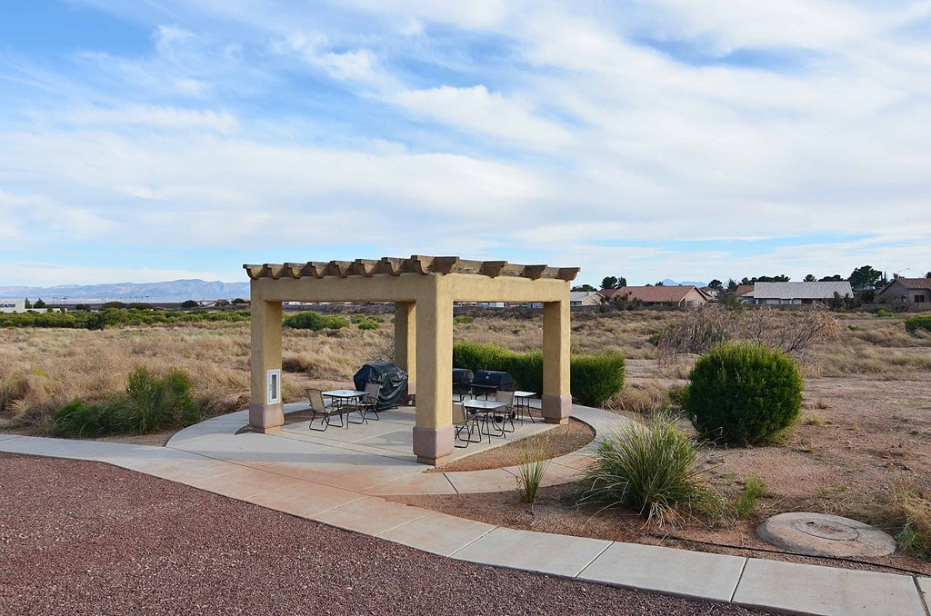 a patio with a pavilion and tables in a desert