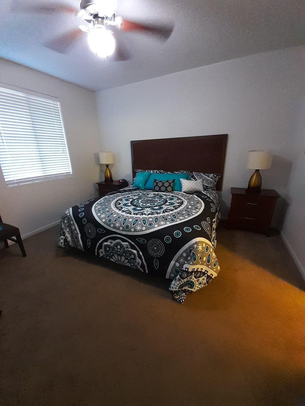 a bedroom with a bed and a ceiling fan