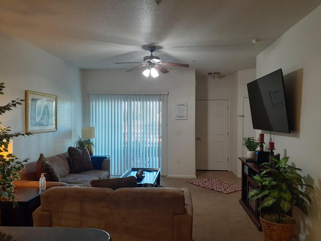 a living room with a couch and a ceiling fan
