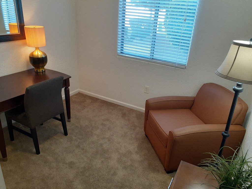 a living room with a couch and a table and a window