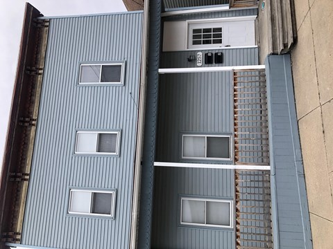 the top of a blue building with windows