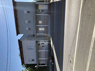 an aerial view of an apartment building with a car parked outside