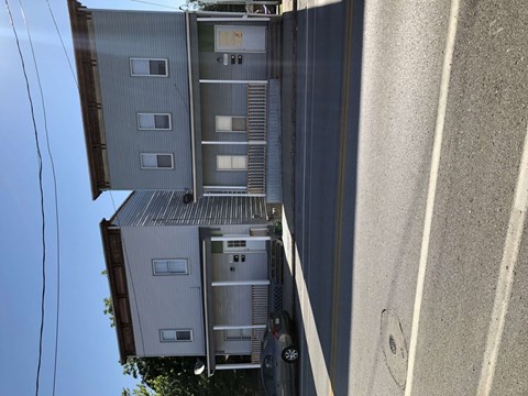 an aerial view of an apartment building with a car parked outside