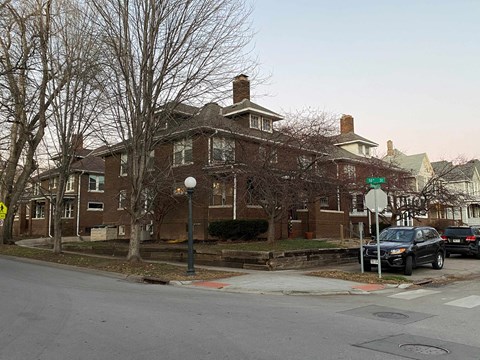 a large brick house with cars parked in front of it