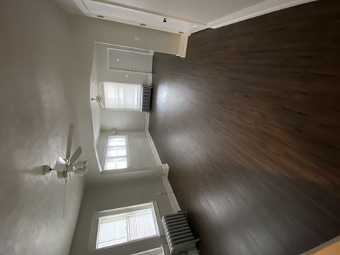 an overhead view of a room with a window and a ceiling fan