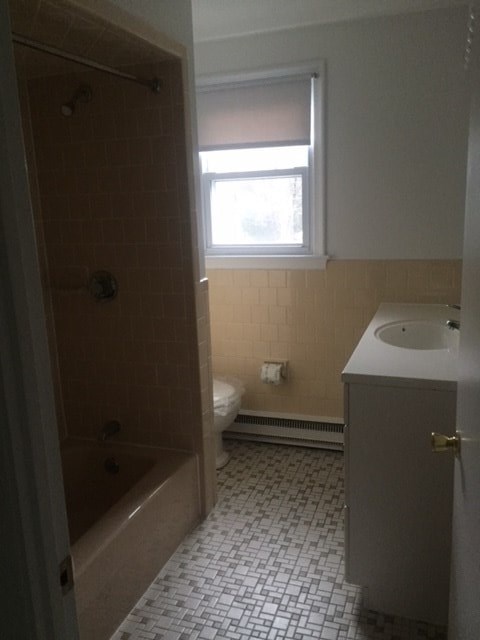 a bathroom with a toilet and a sink and a window