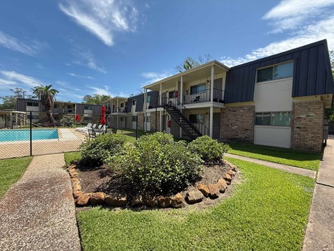 A building with a pool in front of it.
