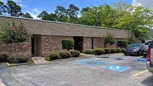 an empty parking lot in front of a brick building