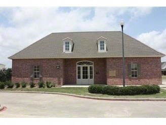 this is a picture of a brick house with a lawn