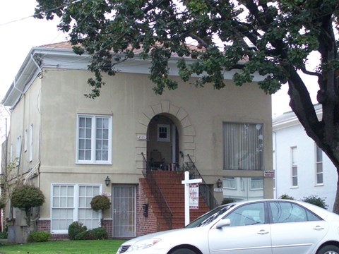 a white car parked in front of a house