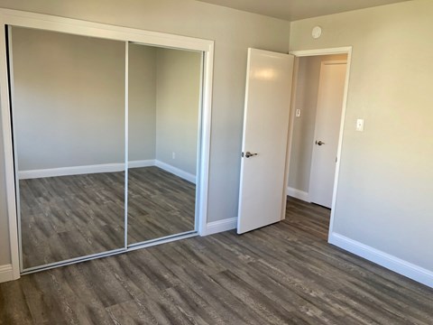 A room with a sliding door and a white door.
