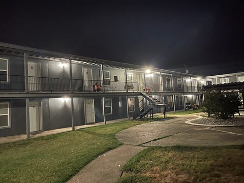 the apartment building is lit up at night