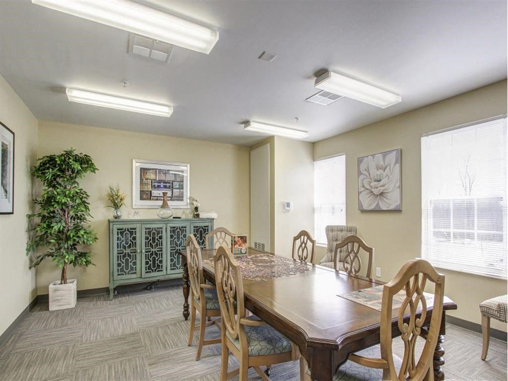 a dining room with a wooden table and chairs