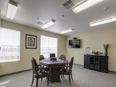 a conference room with a table and chairs and a tv