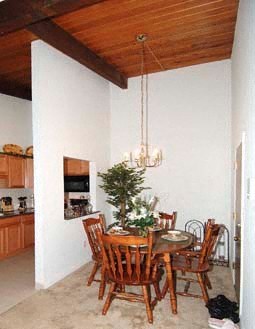 a dining room with a wooden table and chairs