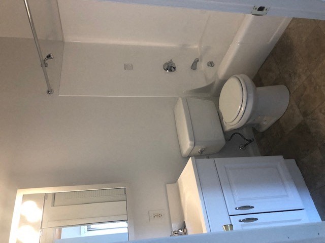 a white bathroom with a toilet and a sink