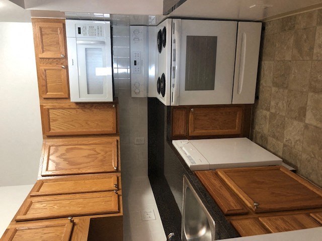 a kitchen with wooden cabinets and white appliances