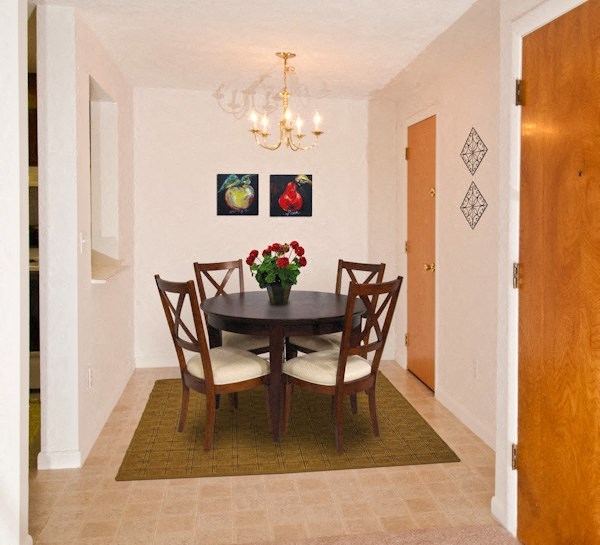 a dining room with a table and chairs