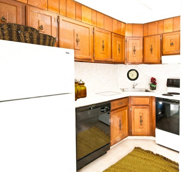 a kitchen with wooden cabinets and a white refrigerator