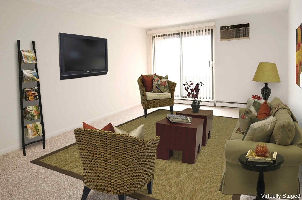 a living room with a couch and chairs and a television