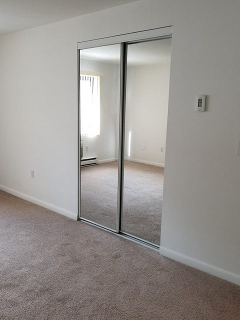 a room with a mirror in the middle of it