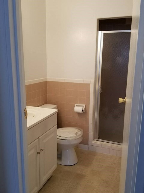 a bathroom with a toilet and a shower