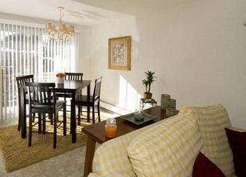 a living room with a couch and a dining room table