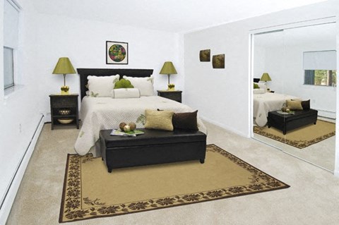 a bedroom with a large bed and a mirror