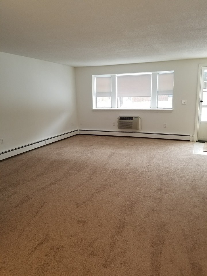 the living room of an empty house with a window