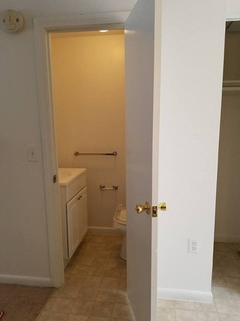 an empty bathroom with a toilet and a sink