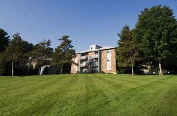 a large grass field in front of a building