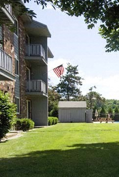 an flag is flying on the side of an apartment building