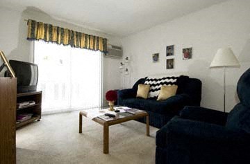 a living room with two blue couches and a coffee table