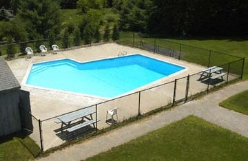 an aerial view of a swimming pool in a backyard