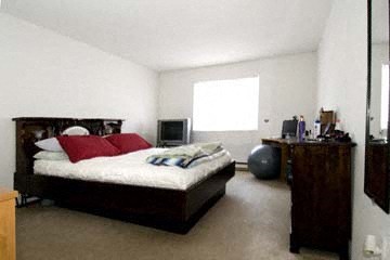 a bedroom with a bed and a tv