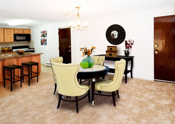 a dining room and living room with a table and chairs