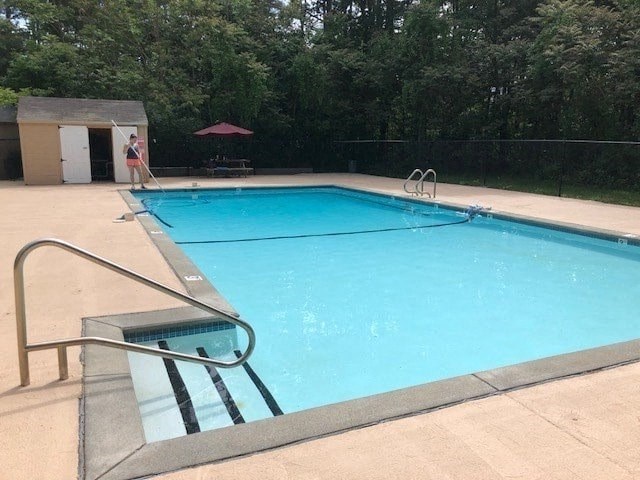 a swimming pool with a person standing next to it