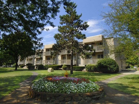 the view of a building with a garden in front of it