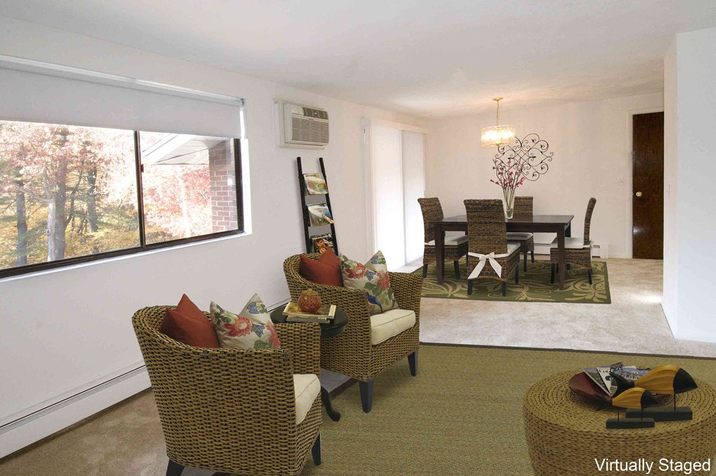 a living room and dining room with a table and chairs