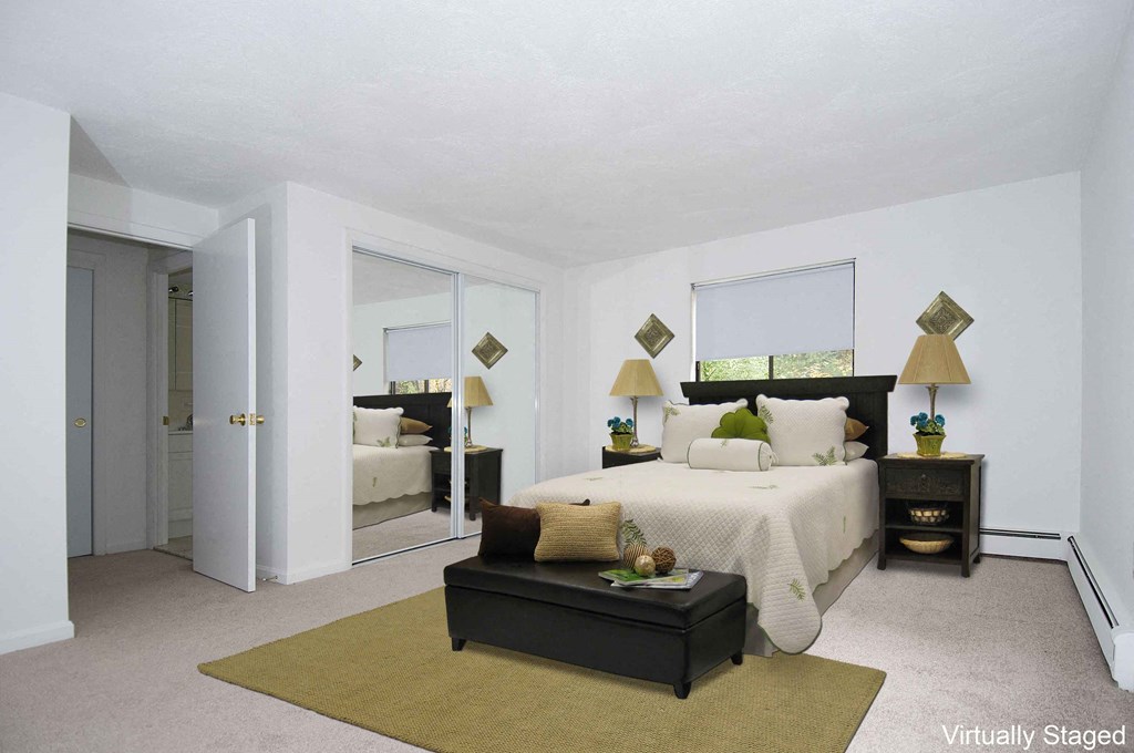 a bedroom with a large bed and a mirror