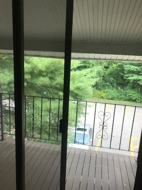 a balcony with a view of a yard and trees