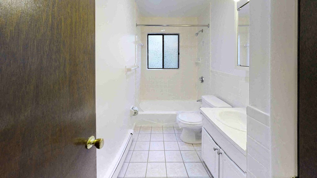 a bathroom with a toilet and a sink and a window