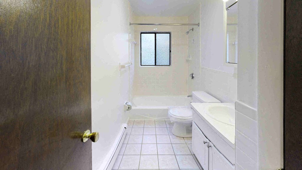 a bathroom with a toilet and a sink and a window