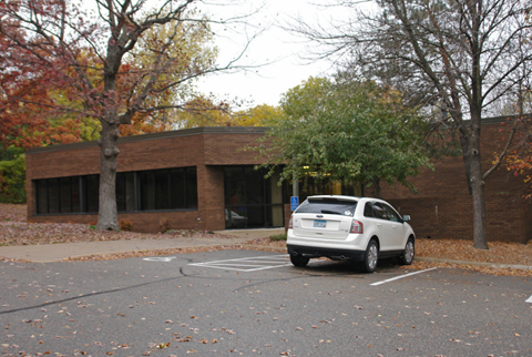 a car parked in a parking lot in front of a building